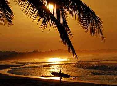 Surfing on the beach in sunset in Mal Pais and Santa Teresa, Costa Rica Central America