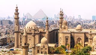 the dusty city of Giza with the pyramids in the background in egypt