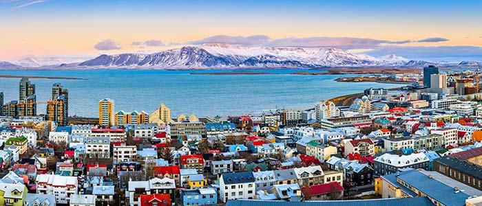 aerial view of reykjavik on tour in iceland colourful houses big blue lake mountains in background