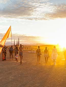 people walking into the desert for midburn festival negev israel