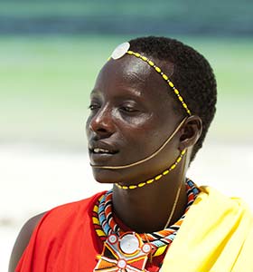 Man in Kenya wearing traditional tribal clothing and head gear