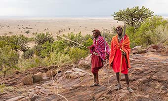 two kenyan people dressed in tribal clothing no the desert planes of kenya