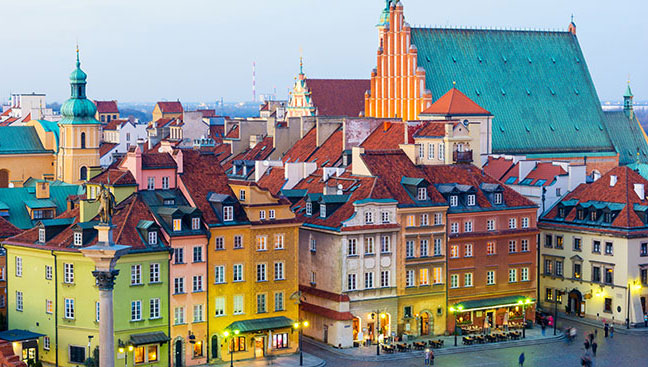 colourful buildings and lit streets of warsaw capital city of poland