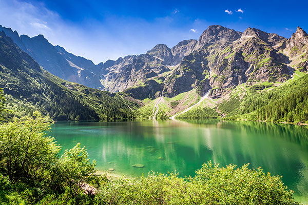 high tatras mountains and green lake during summer hiking in poland