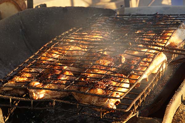 traditional tanzanian food of meat grilling on a bbq at nyama choma festival