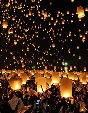 Lanterns floating into the sky during the celebrations at Loi Krathong