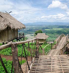 remote village and huts in uganda overlooking green hills and countryside