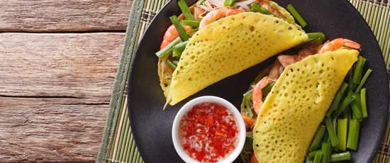 Vietnamese banh xeo crepes stuffed with pork, shrimp and onion