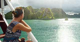 female solo traveller on holiday in vietnam discovering halong bay by boat