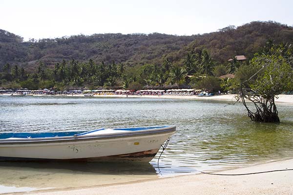 boat floating in the water in the cove of playa las gatas one of the best beaches in mexico