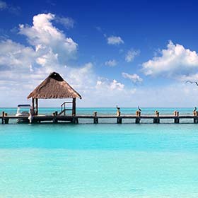 clear sea and wooden boardwalk best time to visit mexico beaches