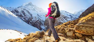 solo traveler hiking in nepal admiring the view of her surroundings, best time to go hiking in nepal