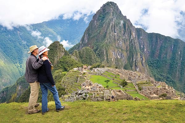 a couple at machu picchu, group travel to peru, tours to peru, machu picchu tours, hiking the inca trail, inca trail tours