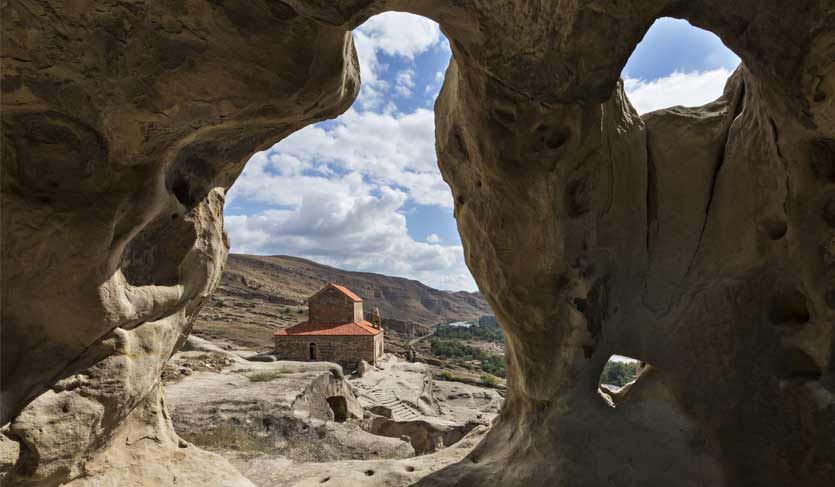 Cave city of Uplistsikhe with the basilica church in the background, in Georgia