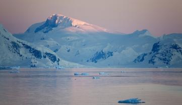 The sun setting over the icebergs, Antarctica