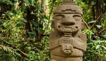 An ancient, flute playing statue in San Agustin, Colombia