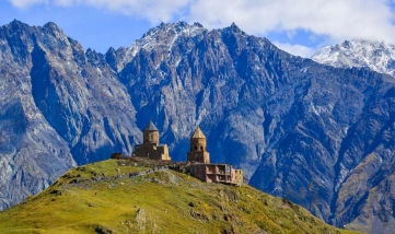 View of Gergeti Trinity Church (Tsminda Sameba) in Kazbegi, Georgia. The Church near the village of Gergeti, under Mount Kazbegi