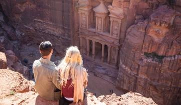 Couple looking down on the ancient temple in Petra