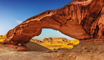 View through a rock arch in the desert of Wadi Rum