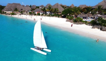 Aerial view of sailboat at sea in Zanzibar beach, Tanzania.